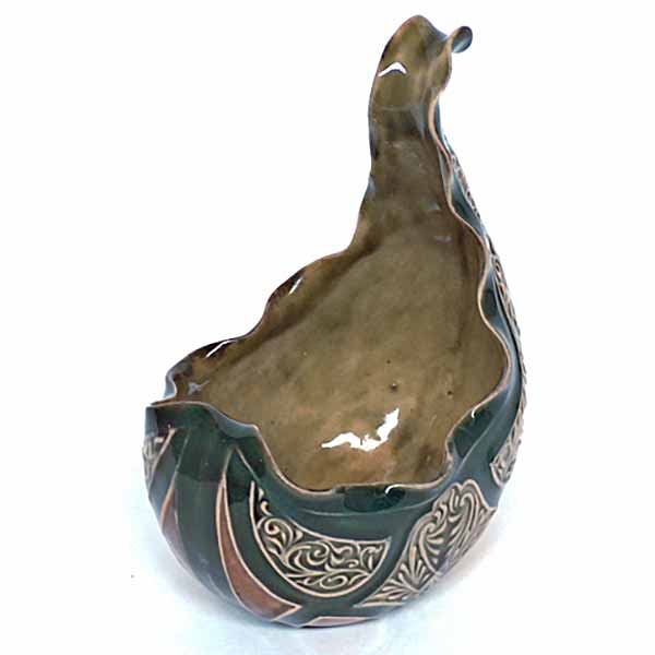 A Doulton Lambeth 5.5in sauceboat with spoon rest by Emily Partington