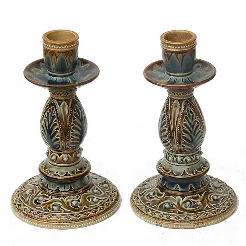 Emily J Edwards - a pair of Doulton Lambeth 7.25in (18cm) candlesticks